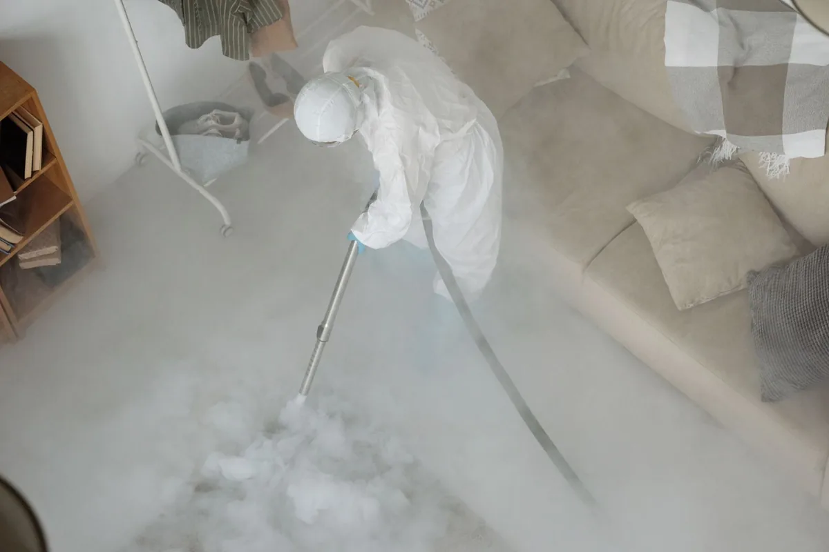 Biohazard cleanup technician in protective equipment, Harrisburg, AR
